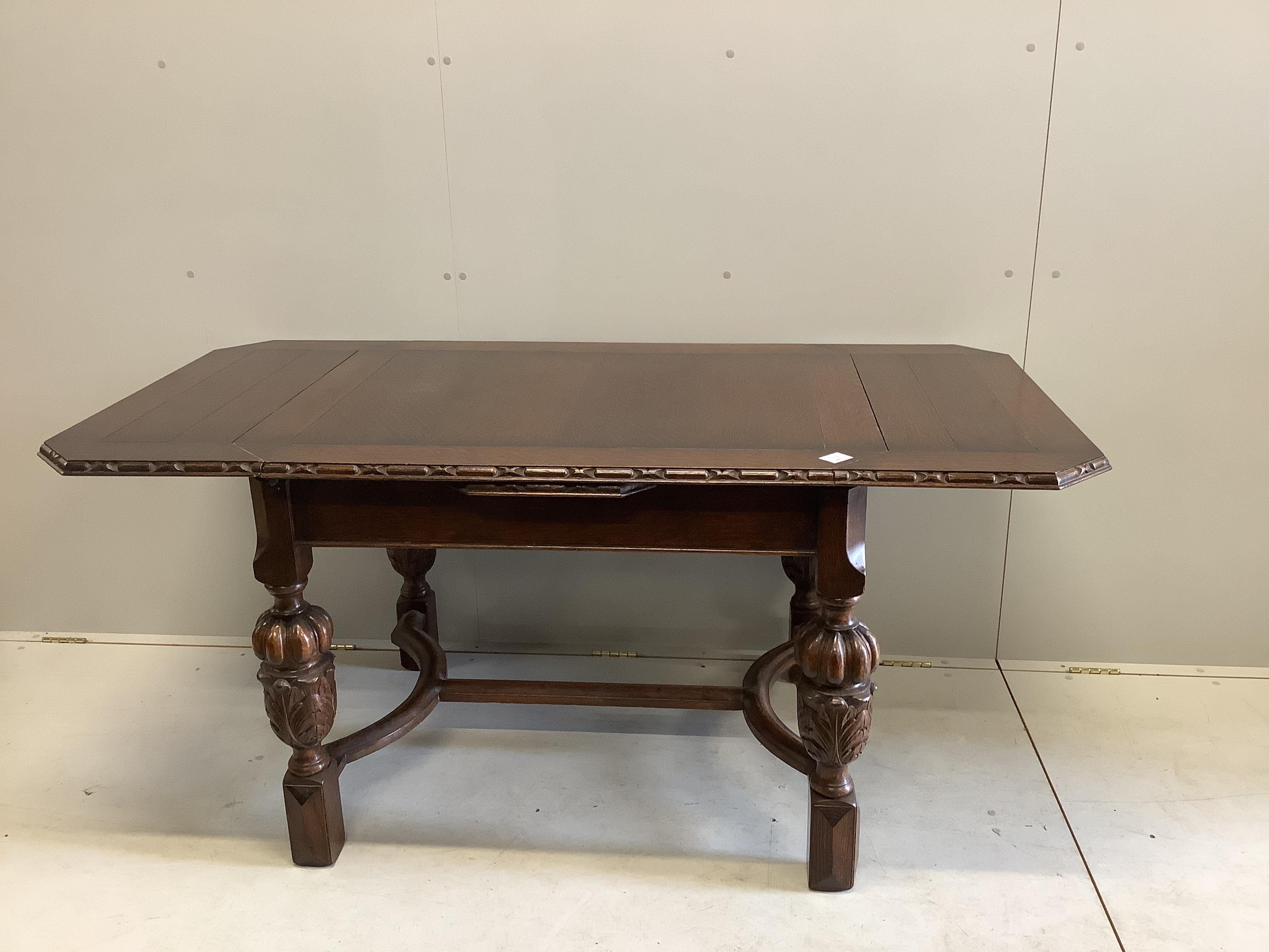 A Jacobean Revival oak draw leaf dining table, width 168cm extended, depth 83cm, height 76cm together with four matching single chairs